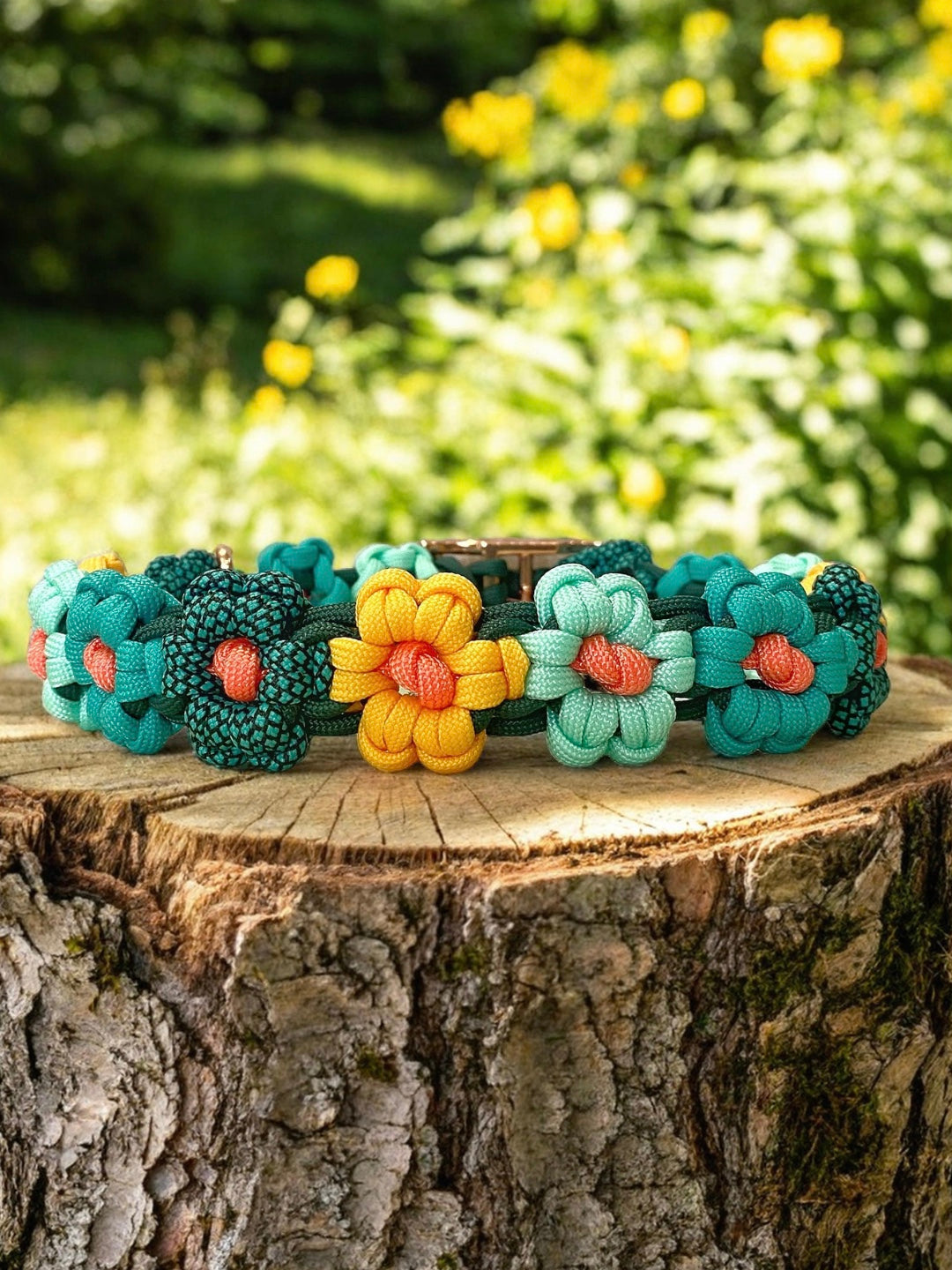 Colorful handmade flower paracord dog collar on a tree stump with a blurred natural background